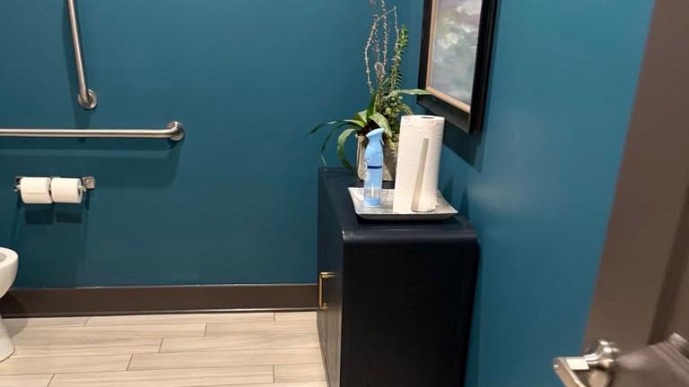 Spotless commercial restroom with polished fixtures and clean tile floor