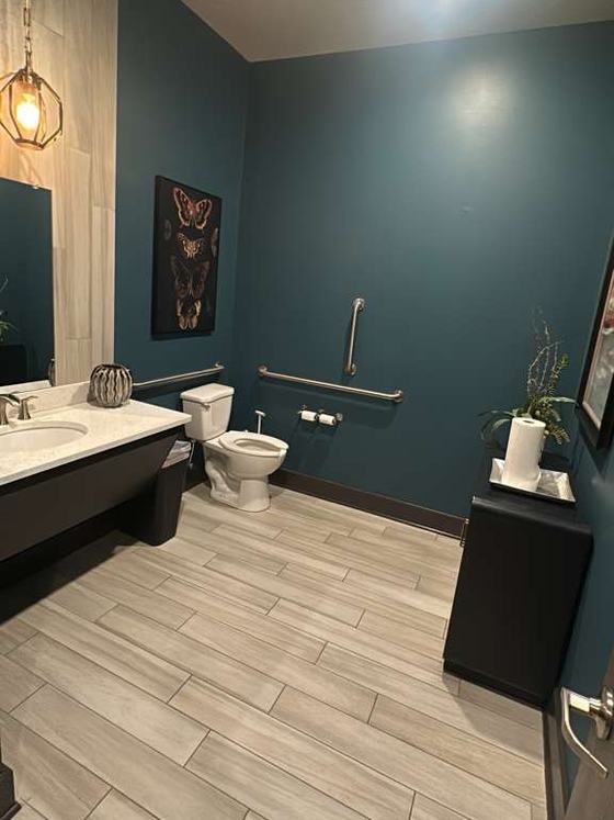 Freshly cleaned restroom with streak-free fixtures and tile floor
