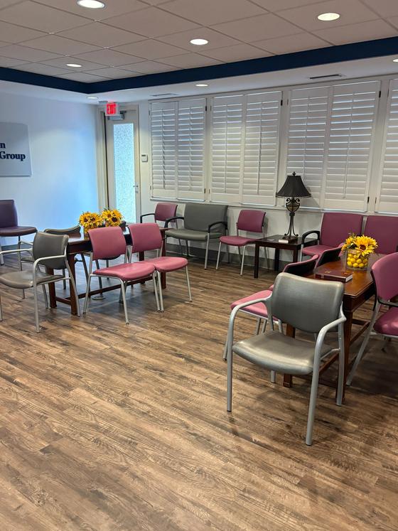 Bright medical waiting room with clean floors and fresh flowers